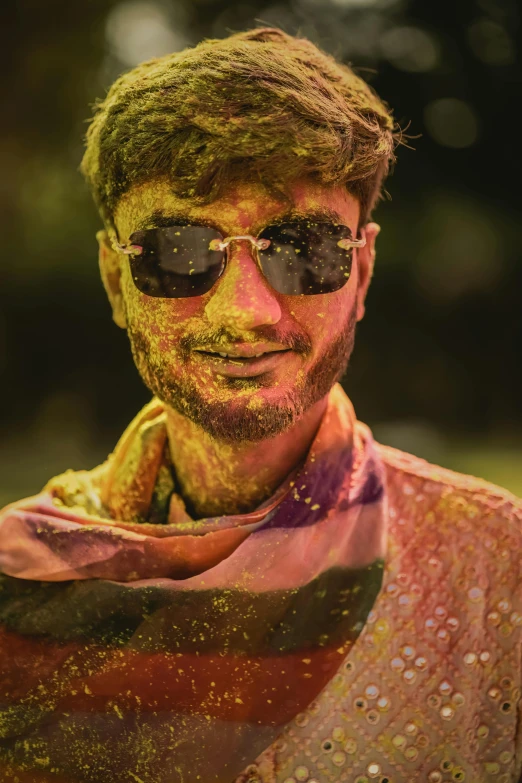 a person covered in yellow and pink paints