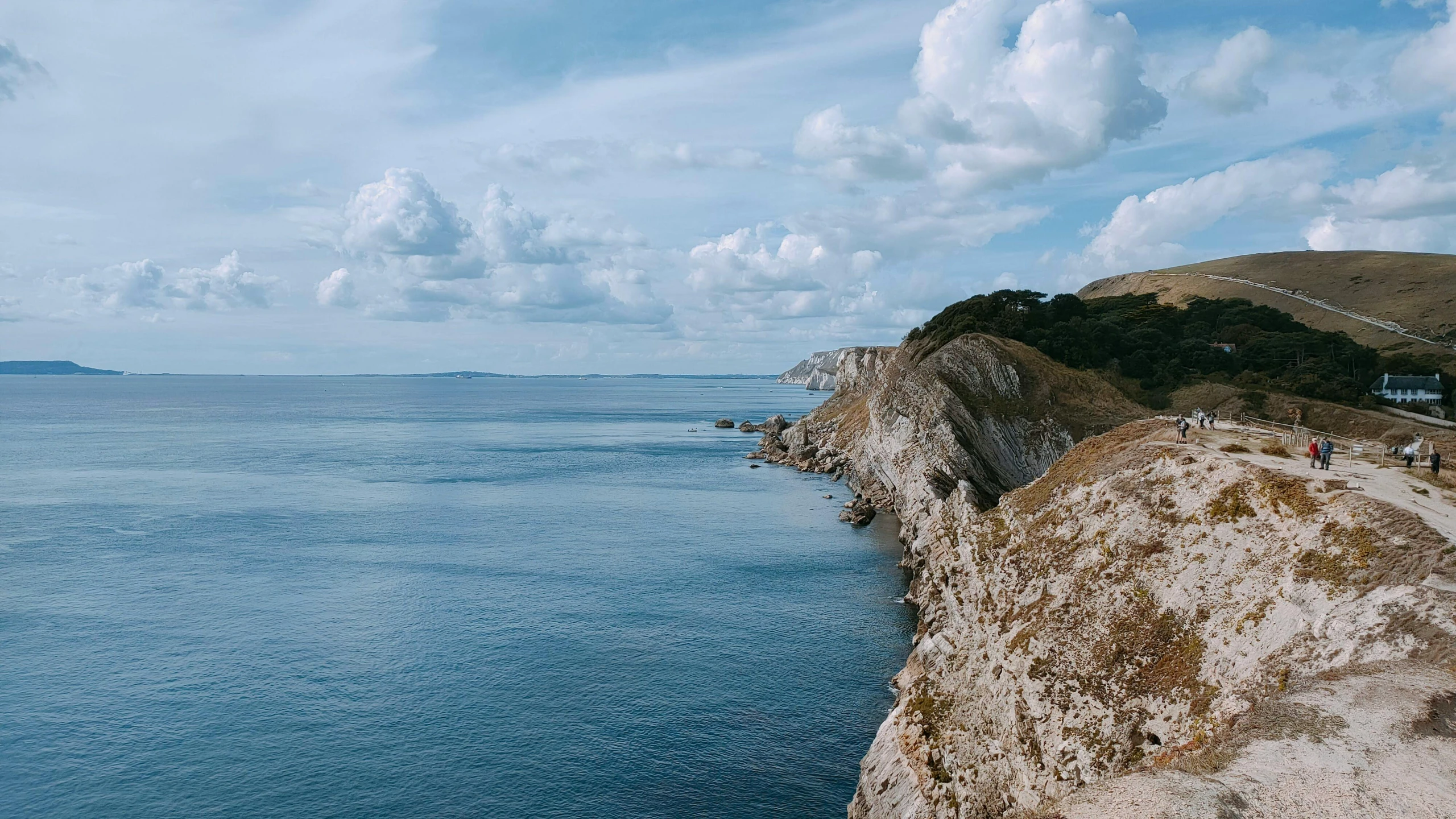 a long body of water with cliffs to the side