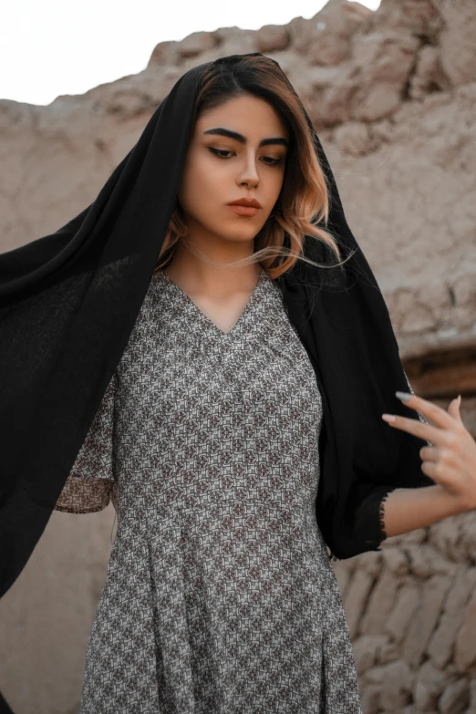 a woman with a black shawl on her head