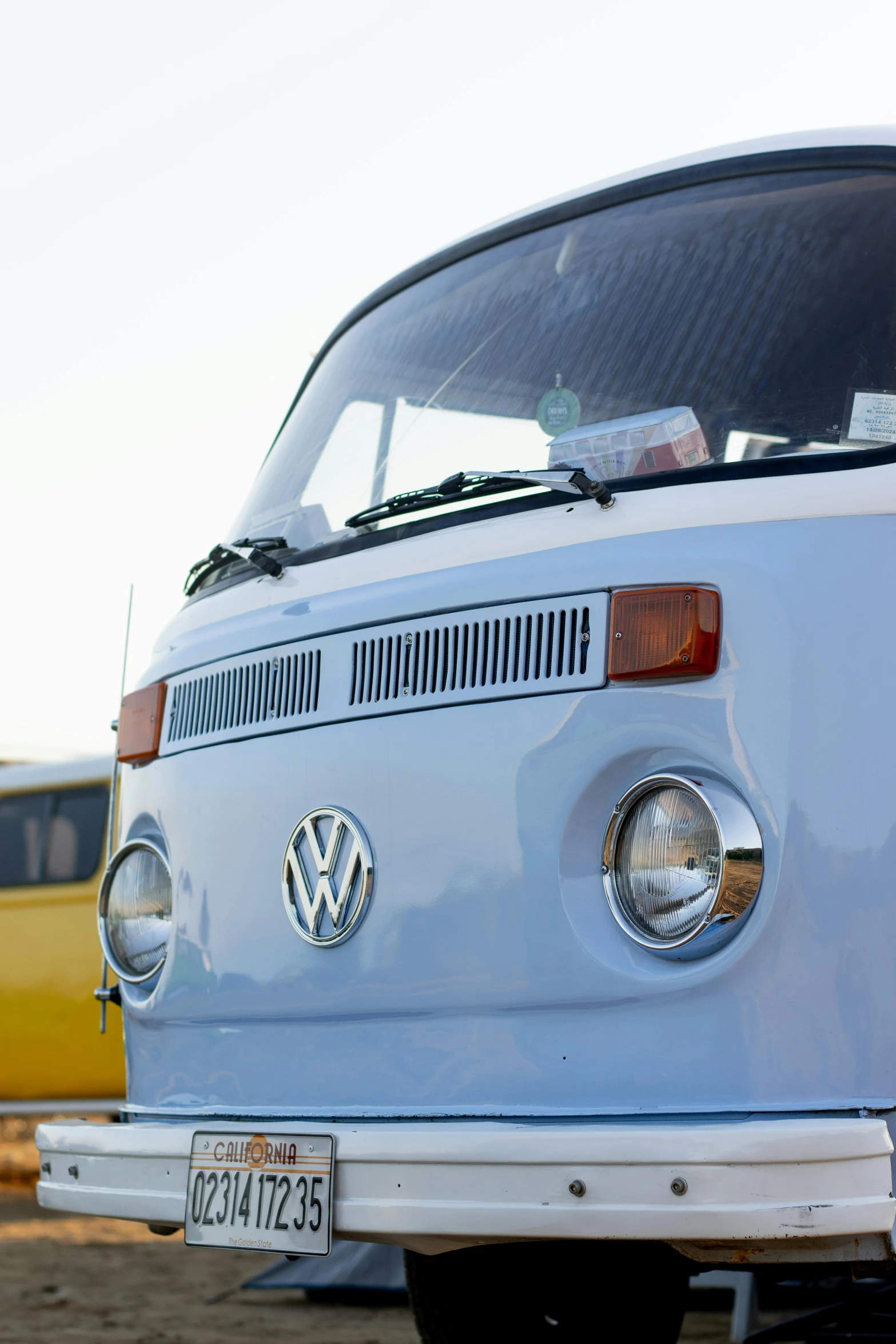 an old volkswagen bus parked in front of some buildings