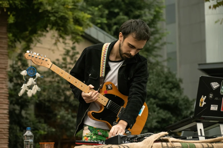 a man in shorts plays the electric guitar