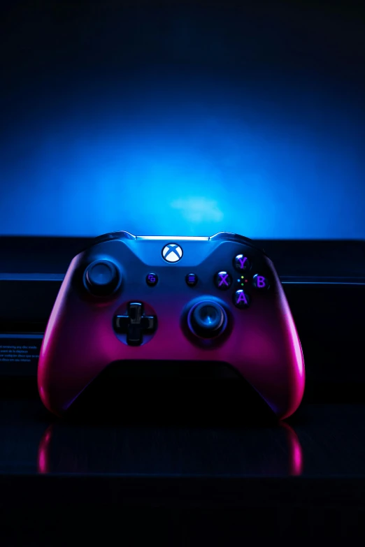 a close up of a controller with a blue light on top