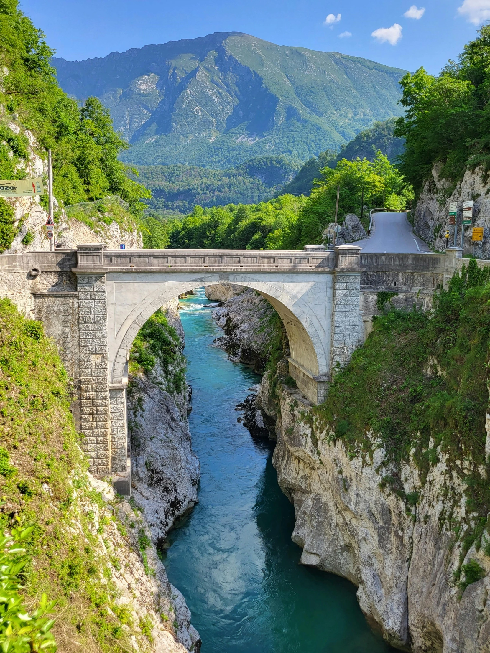 a bridge that looks like it is going under the mountains