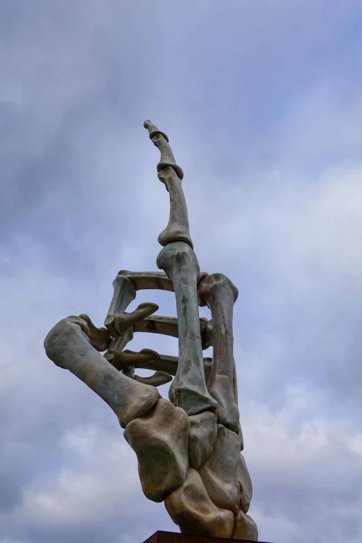 a man reaches up in the air while climbing