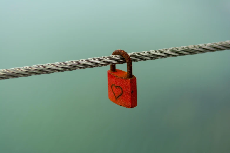 red padlocks on the rope with two hearts in the lock