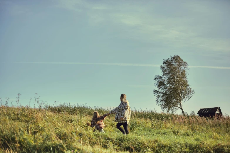 there is a woman and a dog in the grass