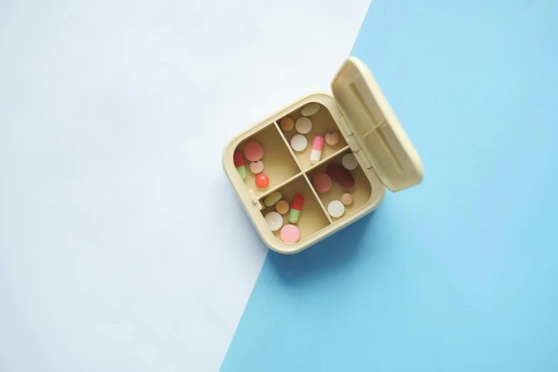 a small container filled with medicine and pills