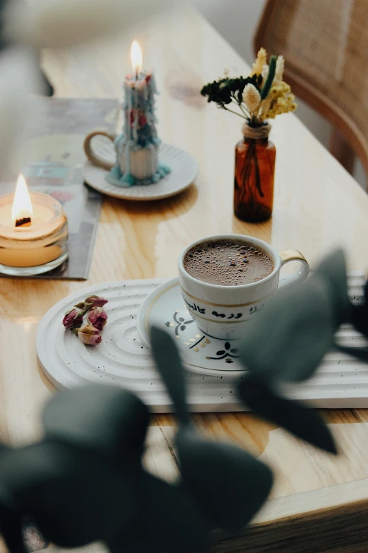 a cup of coffee with a spoon next to it