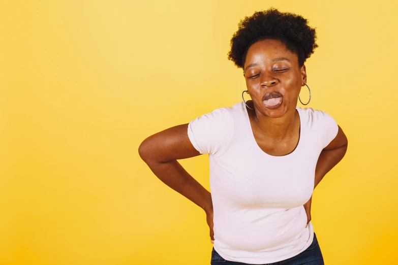 a woman making a goofy face with her hands on her hips