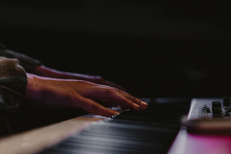 person with their fingers on a musical keyboard
