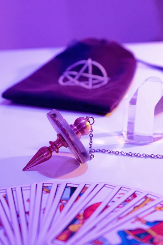 a book and cards on a table with a pen