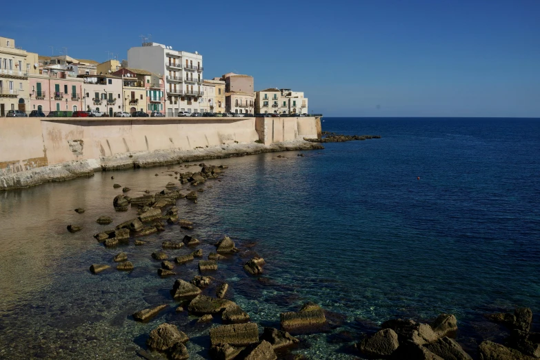 a city with a few buildings at the shore