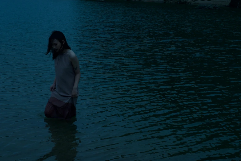 a girl in the water is standing