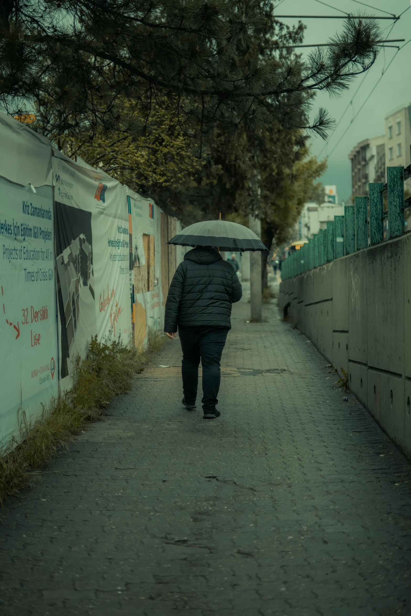 a person walking down a street holding an umbrella