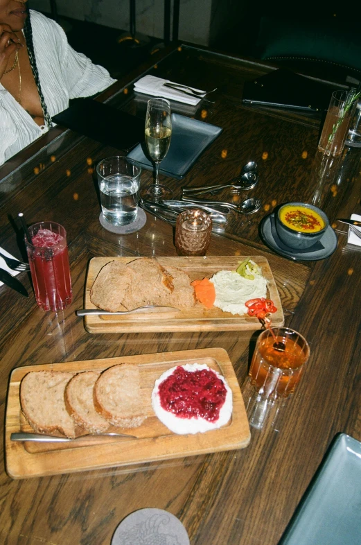 a table with food, drinks and two plates