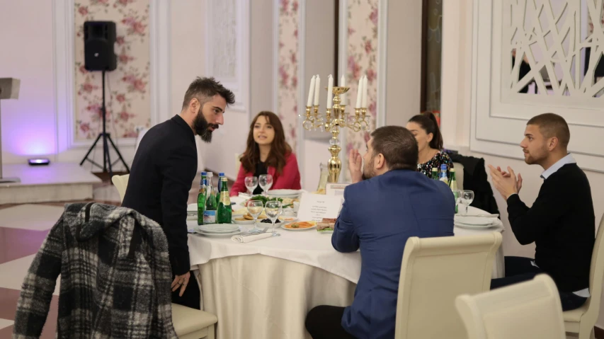 a group of people sit at a table with drinks