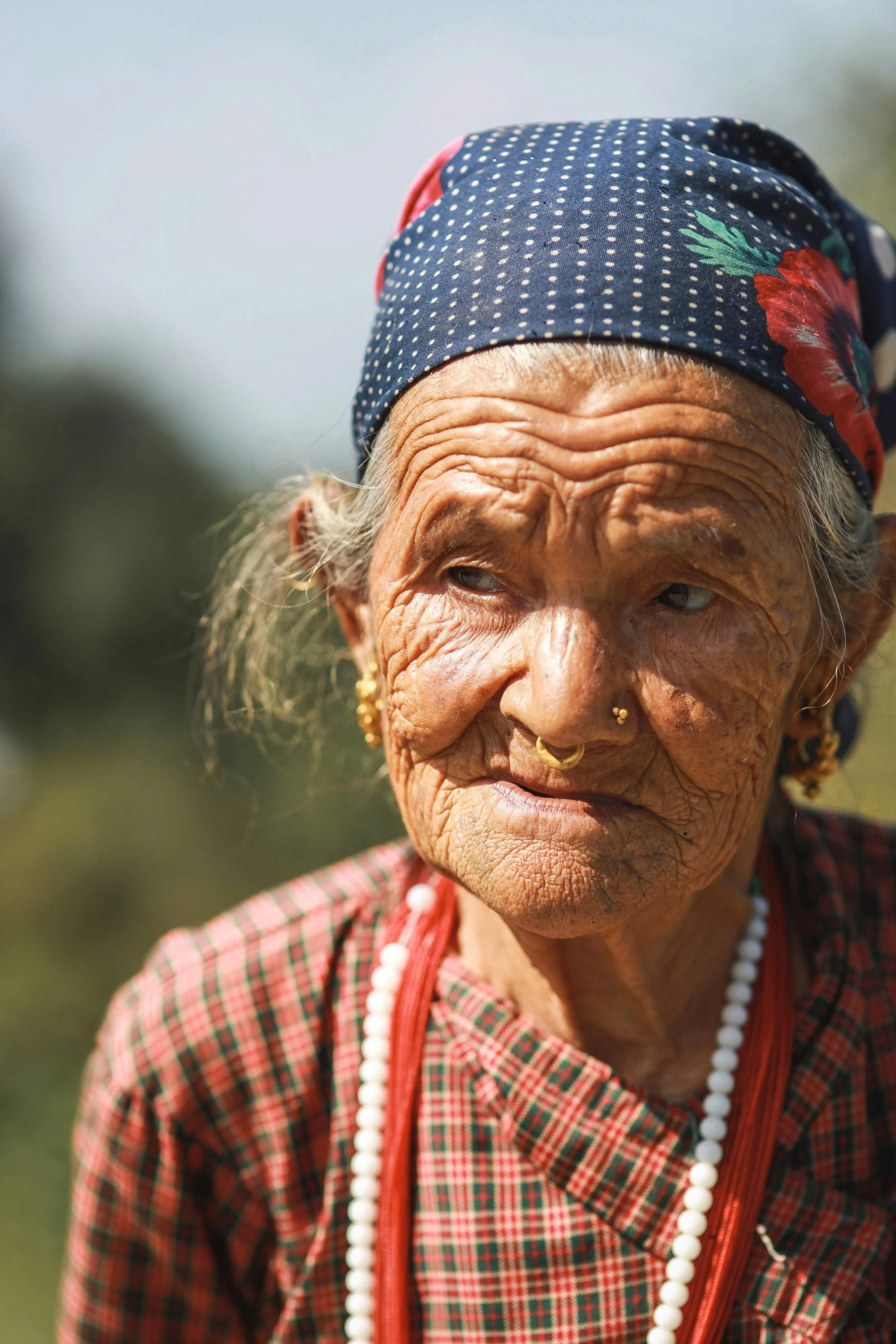 an older woman with a blue flowered headpiece