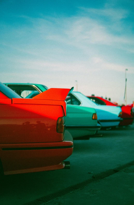 a row of colorful cars on the side of a road