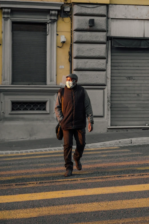 a man with a long mask walking down the street