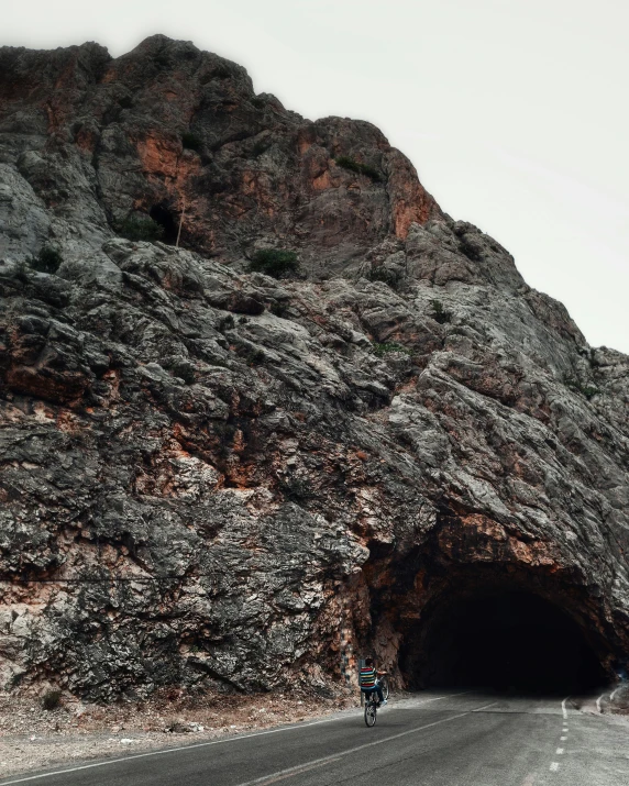 a long tunnel filled with lots of water near a hill