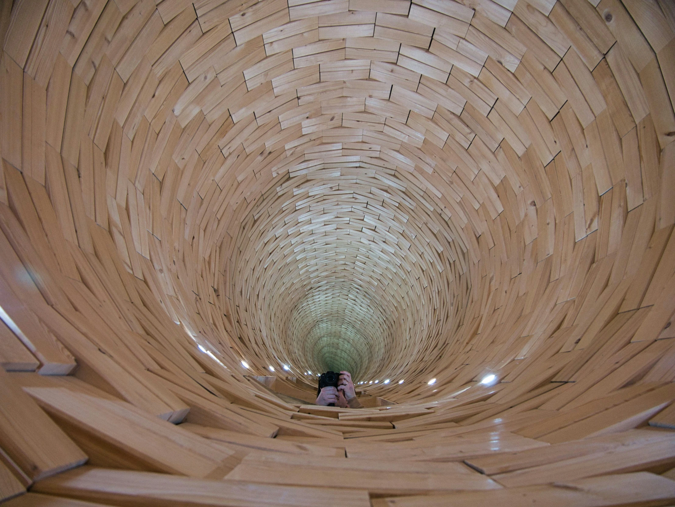 two people walking down a walkway in a decorative building