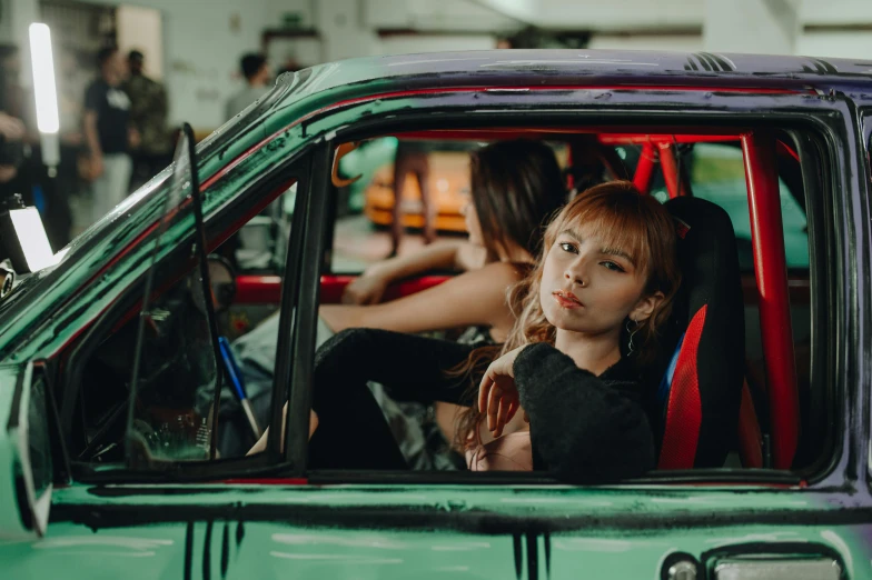 two girls in an old car having a conversation