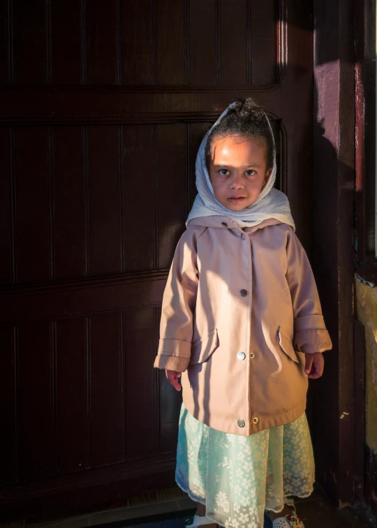 a girl standing in front of a door