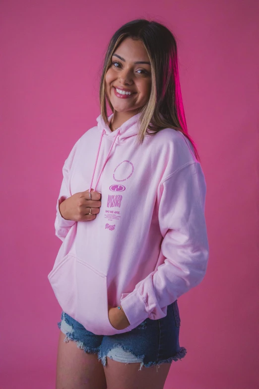 a woman posing for the camera, in a pink sweater