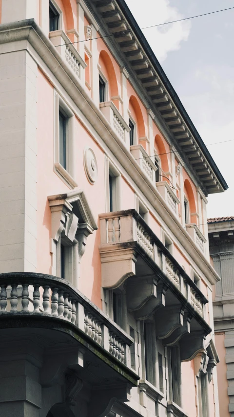 an apartment building with arched balconies, ornate balcony and window