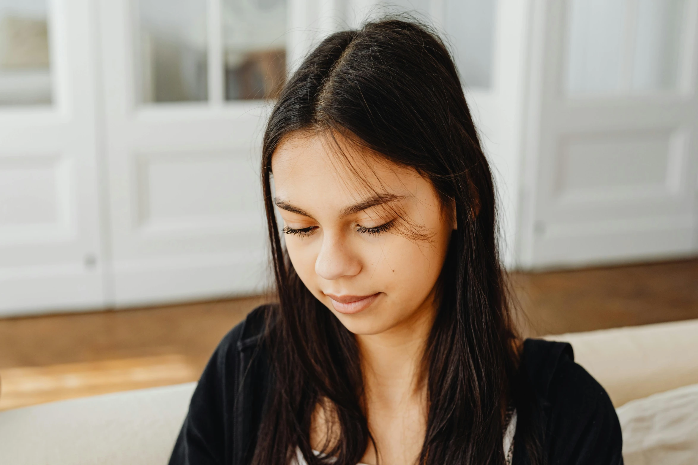 a close up of a person sitting on a couch