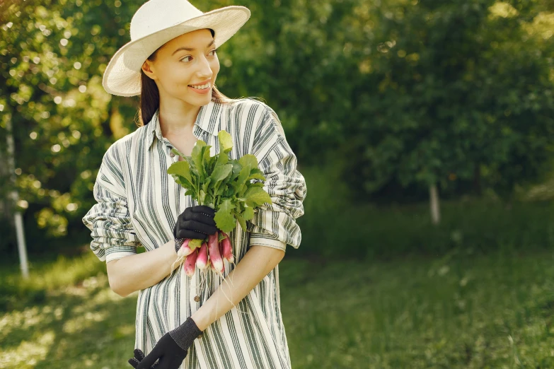 woman in striped shirt with large bouquet of tulips