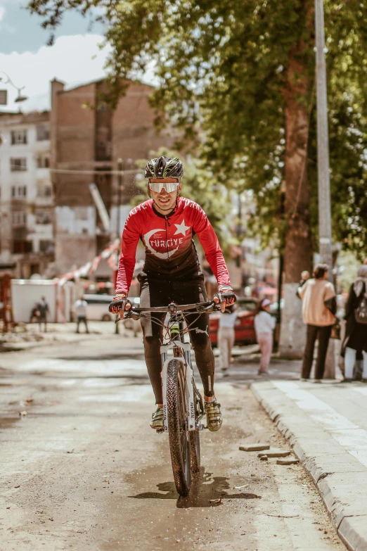 a person riding a bike in the middle of the road