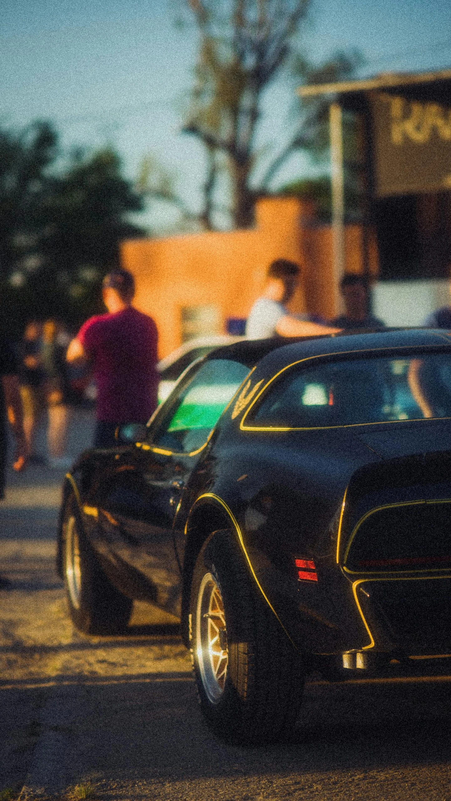 a group of people walking in front of a car