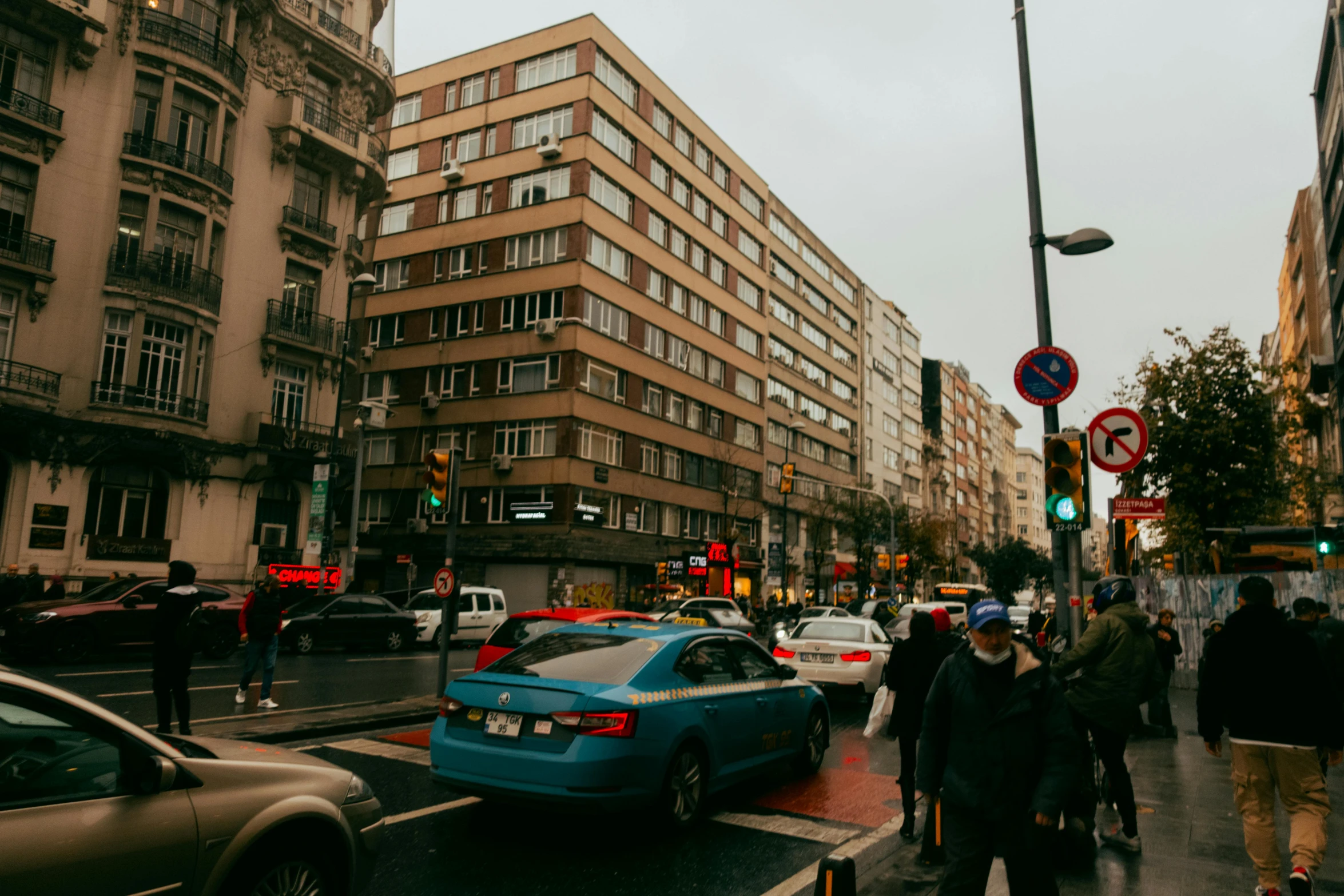 the people are crossing the street with cars