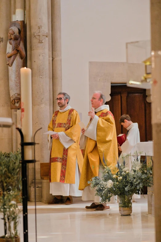 two priests standing side by side on the aisle