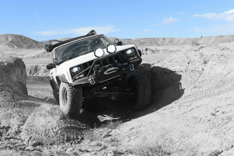 a four - wheeler is stuck in the middle of a desert