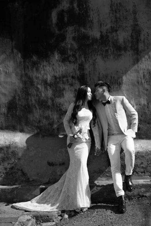 a man and woman dressed in wedding clothes pose for a picture