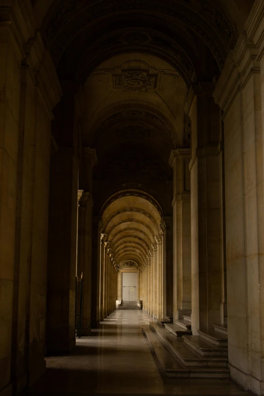 an elegantly designed long building with large columns and marble columns