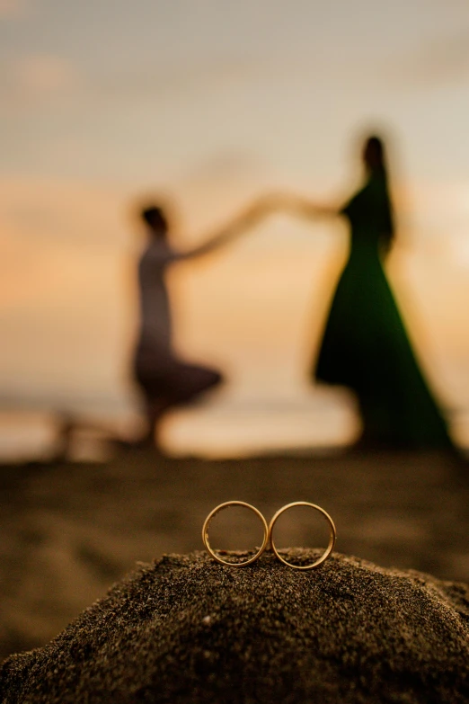 a pair of rings that are laying on the sand