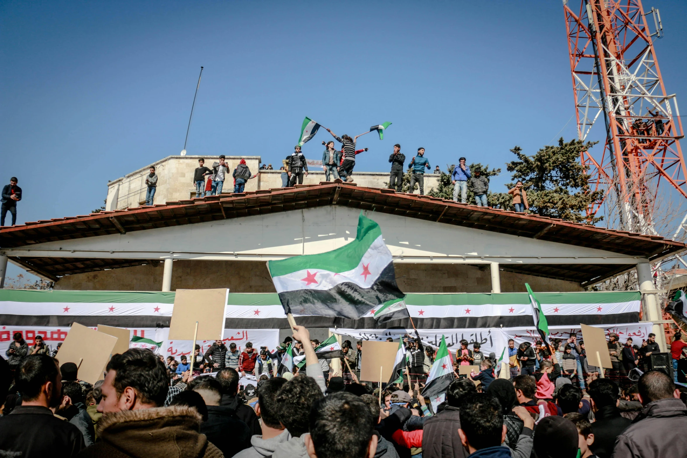 many people in line and some holding flags