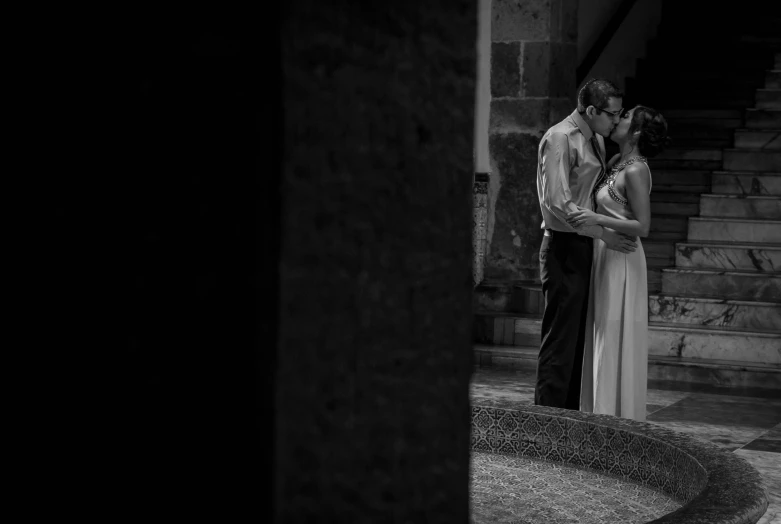 a man standing next to a woman on a stone steps