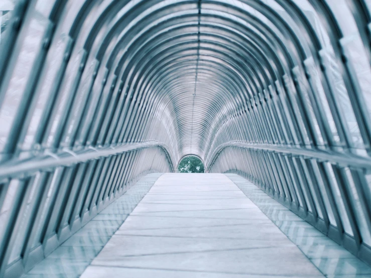 a walkway surrounded by large pipes under a sky