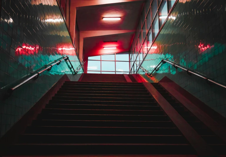 the stairs leading down to a room with bright light