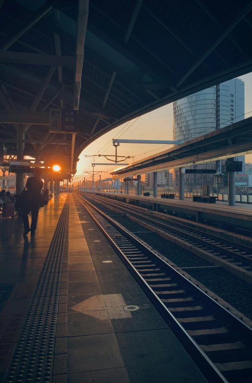 a lone train at the station as the sun is setting