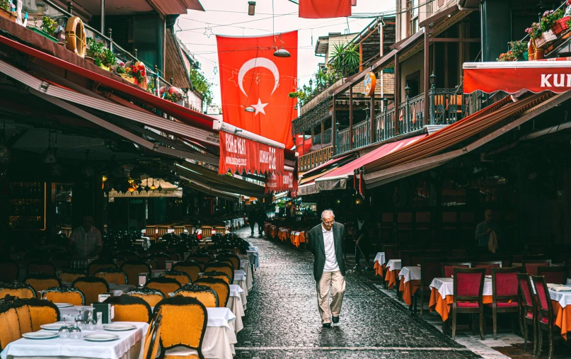 a man walks through a narrow city alley way