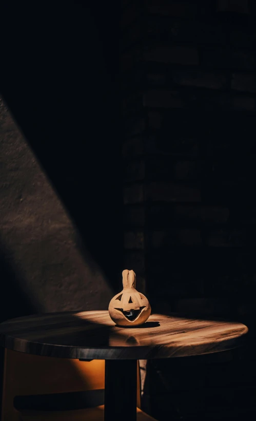 a pottery decoration sitting on top of a wooden table