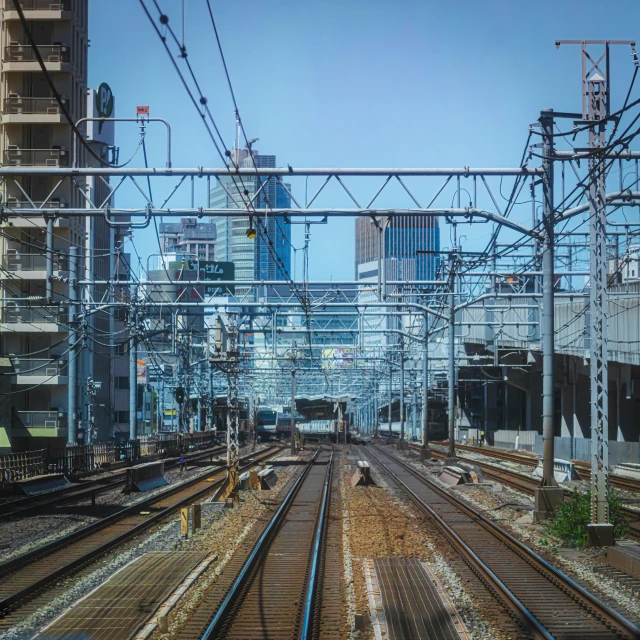 some train tracks with lots of tall buildings in the background