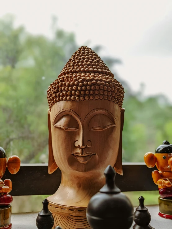 a wooden buddha statue sitting on top of a table