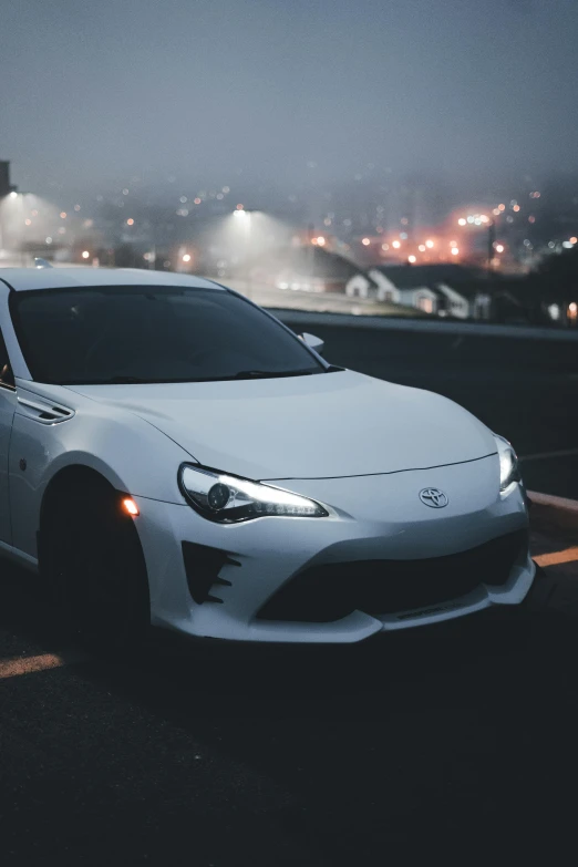 a white sports car is parked outside a parking lot