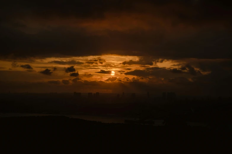 the sun is setting over a very dark sky